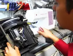Vacuum repair technician servicing internal components on a workbench in Baltimore, MD