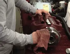 Vacuum repair technician cleaning and servicing a vacuum motor in Baltimore, MD